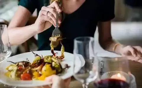 Person enjoying a salad in a restaurant