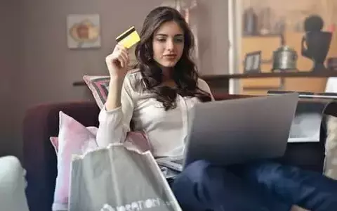 Person sitting on couch shopping online